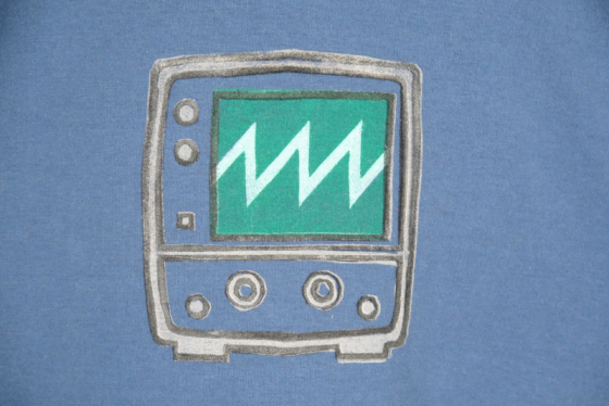 Close up of the block print of an oscilloscope with a sawtooth waveform displayed.
